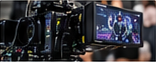Television broadcast truck and control room monitors showing a live game